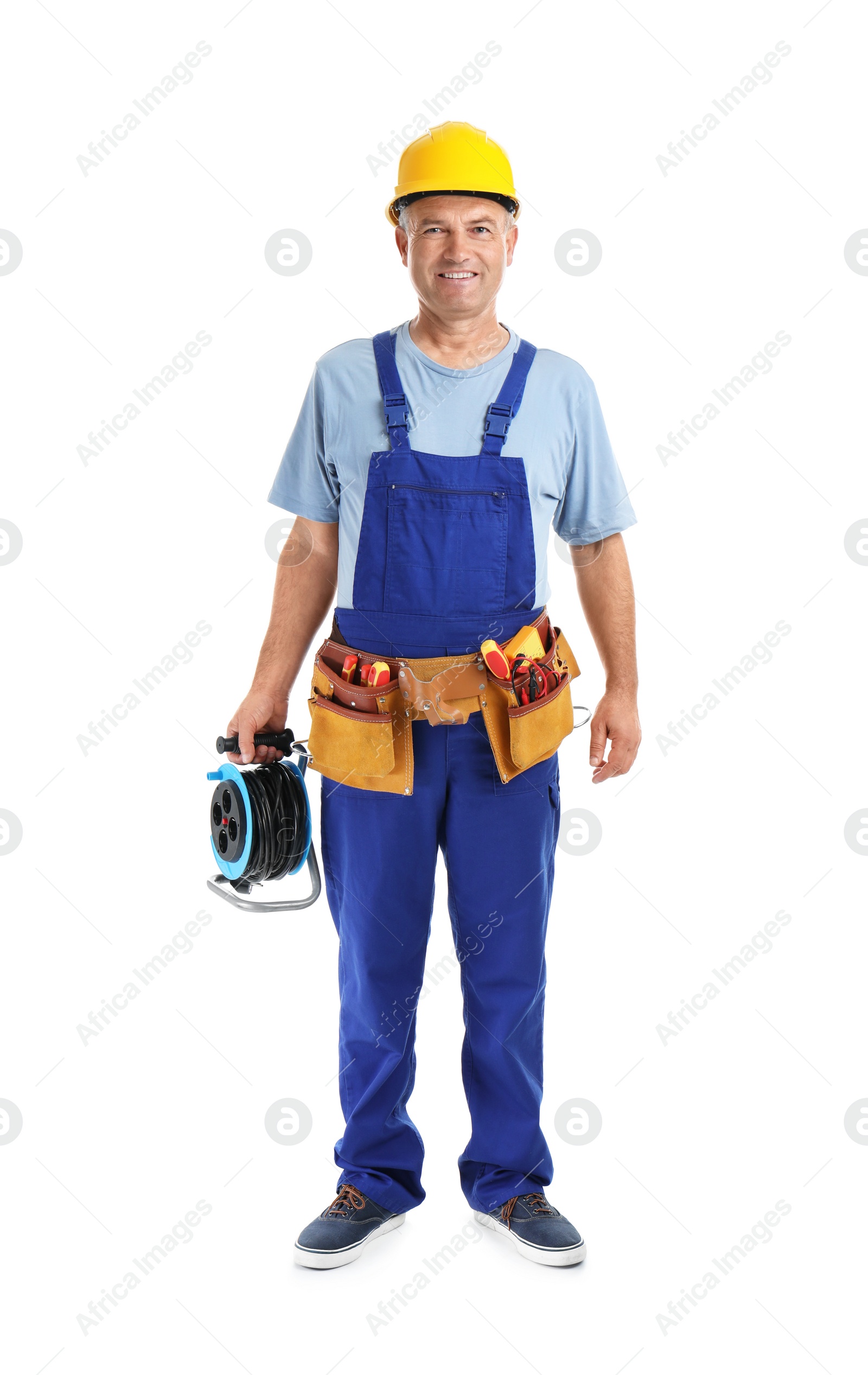 Photo of Electrician with extension cord reel and tools  wearing uniform on white background