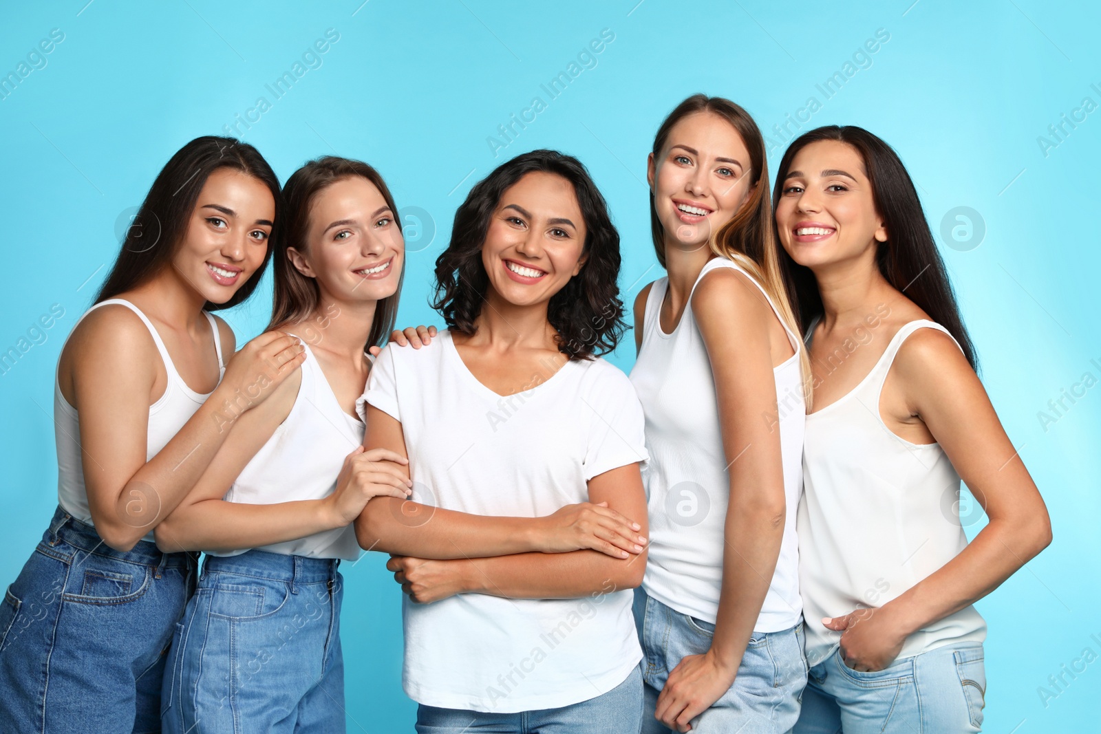 Photo of Happy women on light blue background. Girl power concept