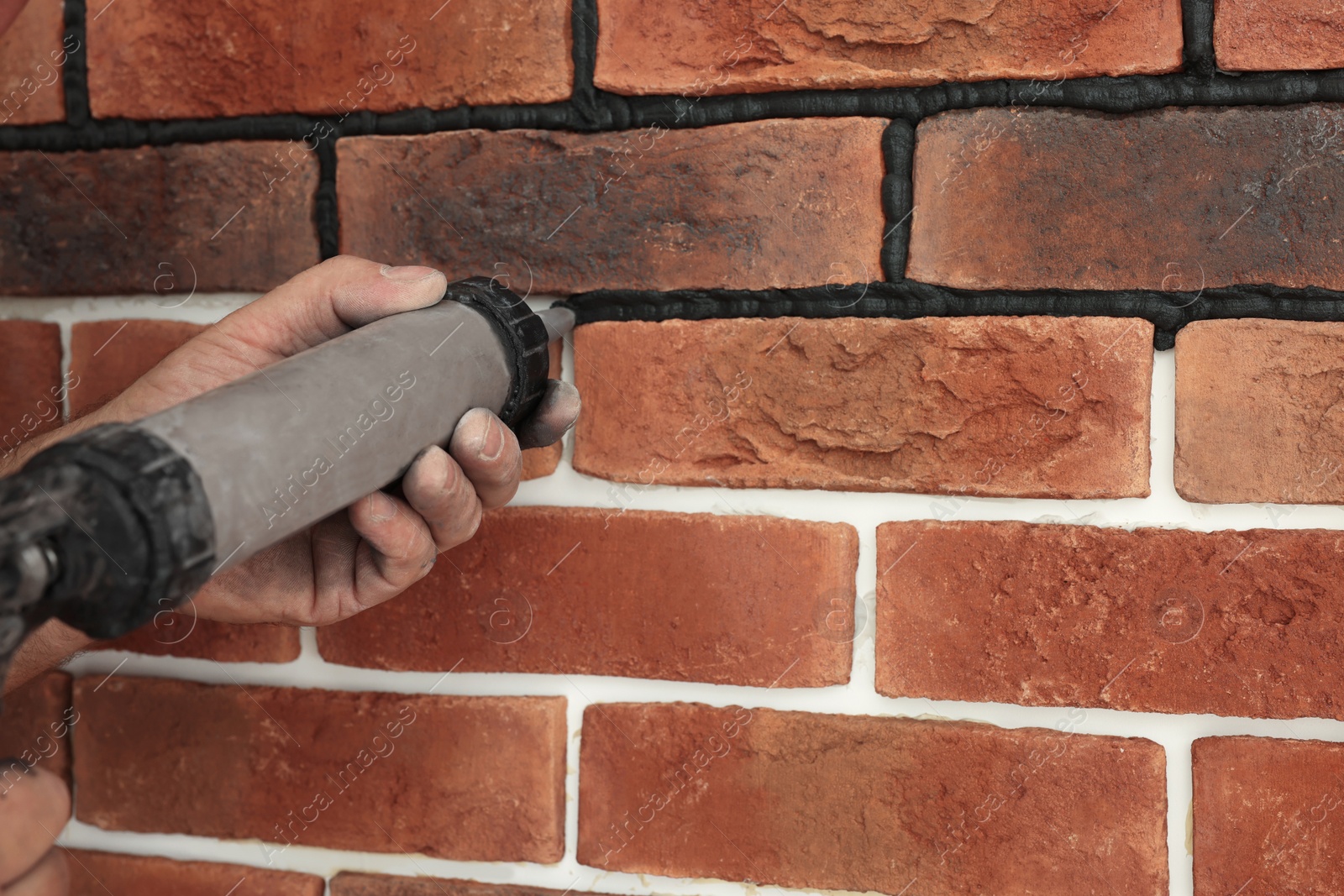 Photo of Professional builder using tiling fugue for grouting, closeup