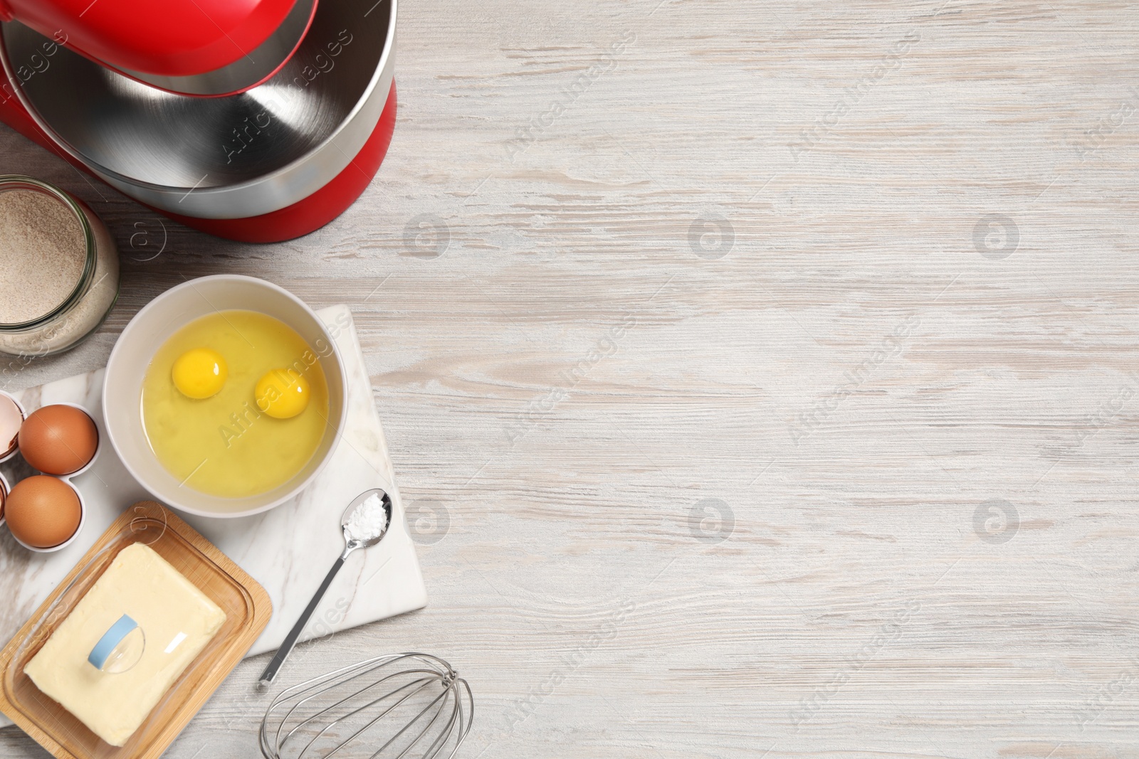 Photo of Modern red stand mixer and different ingredients on white wooden table, flat lay. Space for text