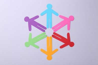 Equality concept. Paper human figures on light background, top view