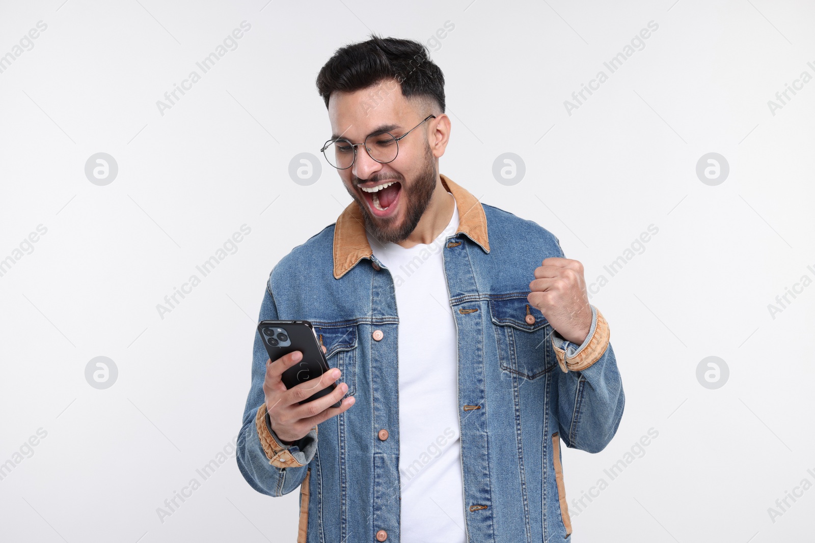 Photo of Happy man using smartphone on white background