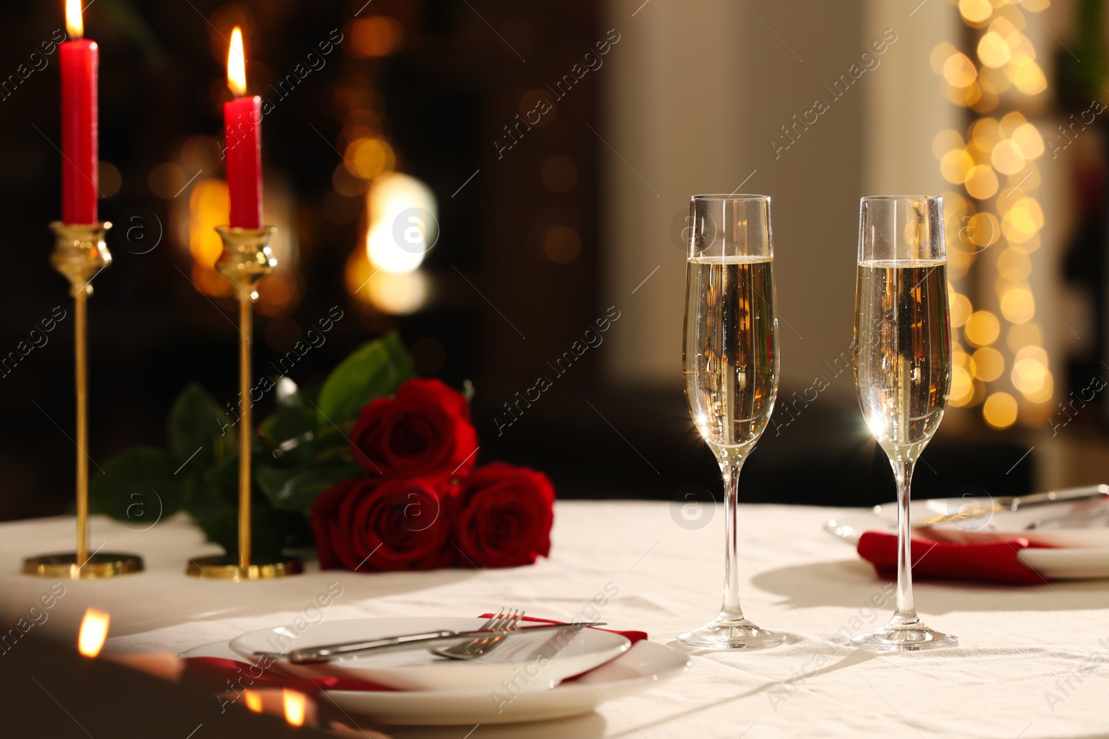 Photo of Romantic dinner table setting with glasses of champagne in restaurant