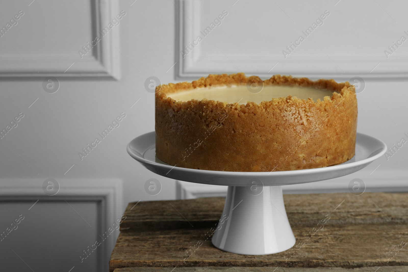 Photo of Tasty vegan tofu cheesecake on wooden table, space for text