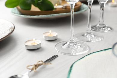 Photo of Elegant table setting with green plants, closeup