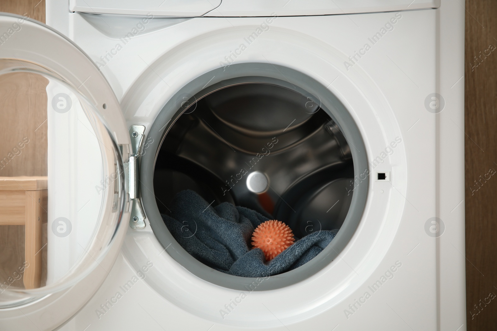 Photo of Dryer ball and towel in washing machine, closeup