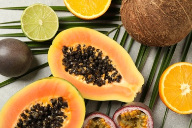 Photo of Fresh ripe papaya and other fruits on light grey table, flat lay