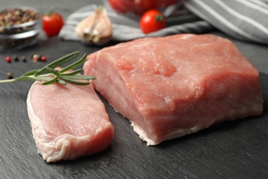 Photo of Fresh raw cut meat on grey table, closeup