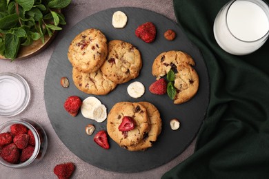 Photo of Cookies with freeze dried fruits, mint and nuts on grey table, flat lay