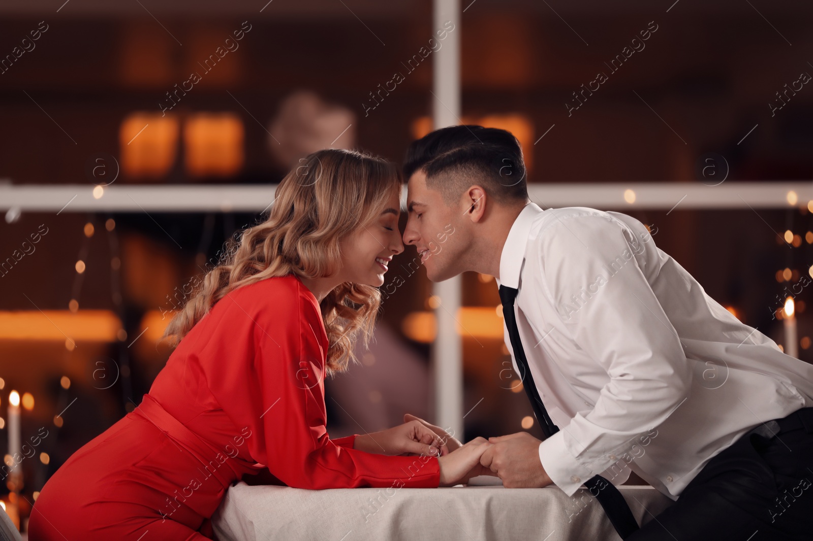 Photo of Lovely couple having romantic dinner on Valentine's day in restaurant