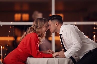 Photo of Lovely couple having romantic dinner on Valentine's day in restaurant