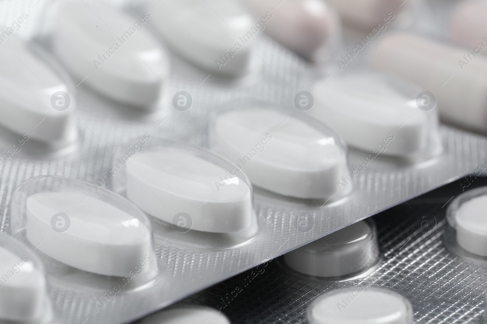 Photo of Pills in blisters as background, closeup view