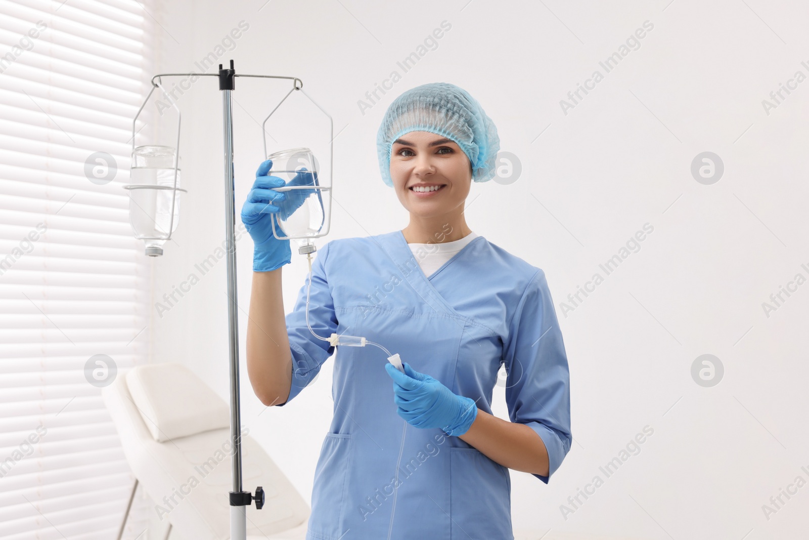 Photo of Nurse setting up IV drip in hospital