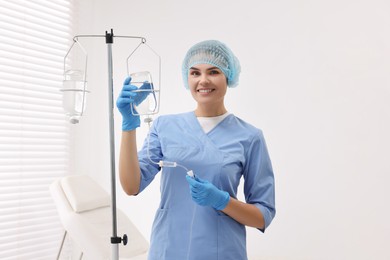 Nurse setting up IV drip in hospital