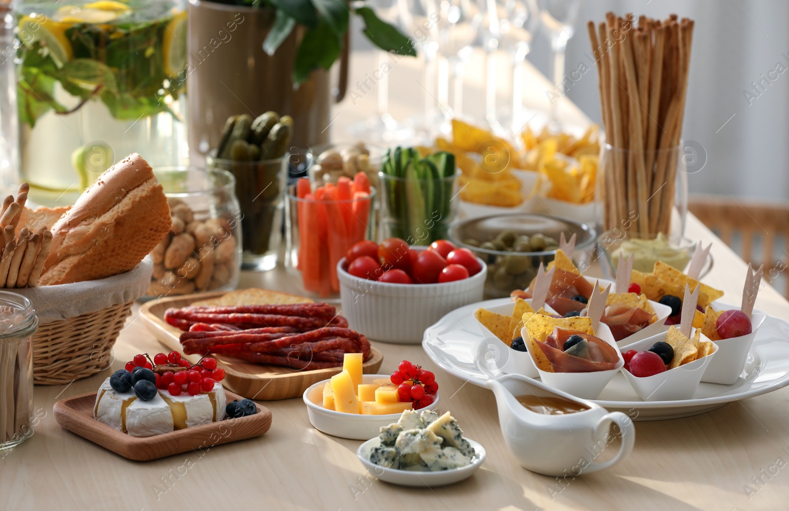 Photo of Variety of snacks on wooden table in buffet style indoors