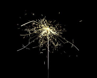 Image of Beautiful sparkler burning on black background. Party decor