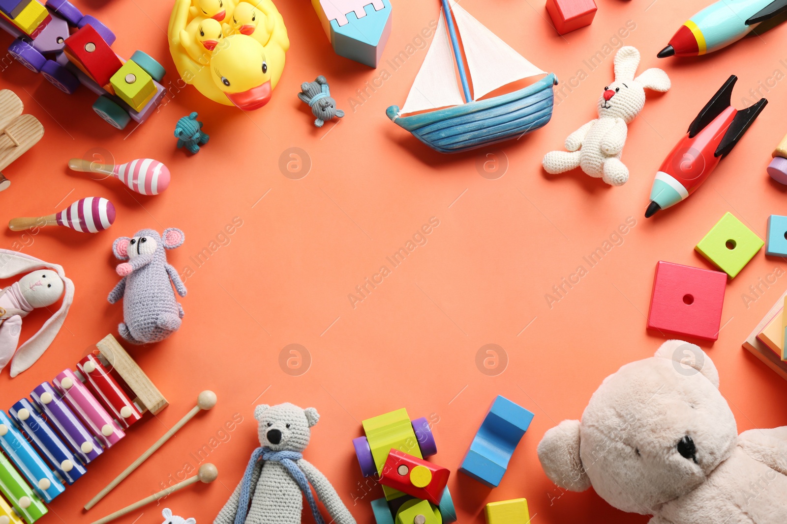 Photo of Frame made of different toys on orange background, flat lay. Space for text