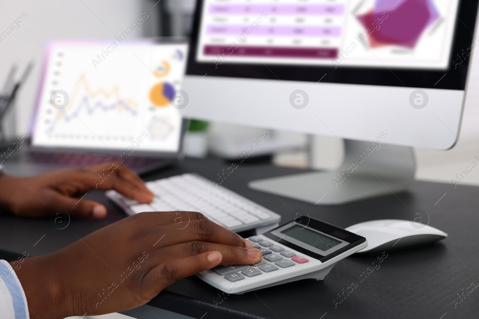 Photo of Professional accountant working at desk in office, closeup