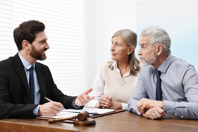 Photo of Senior couple having meeting with lawyer in office