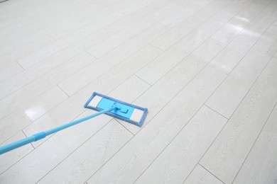 Photo of Washing of parquet floor with mop. Space for text