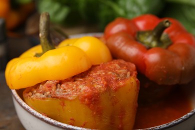 Photo of Delicious stuffed bell peppers on wooden table, closeup