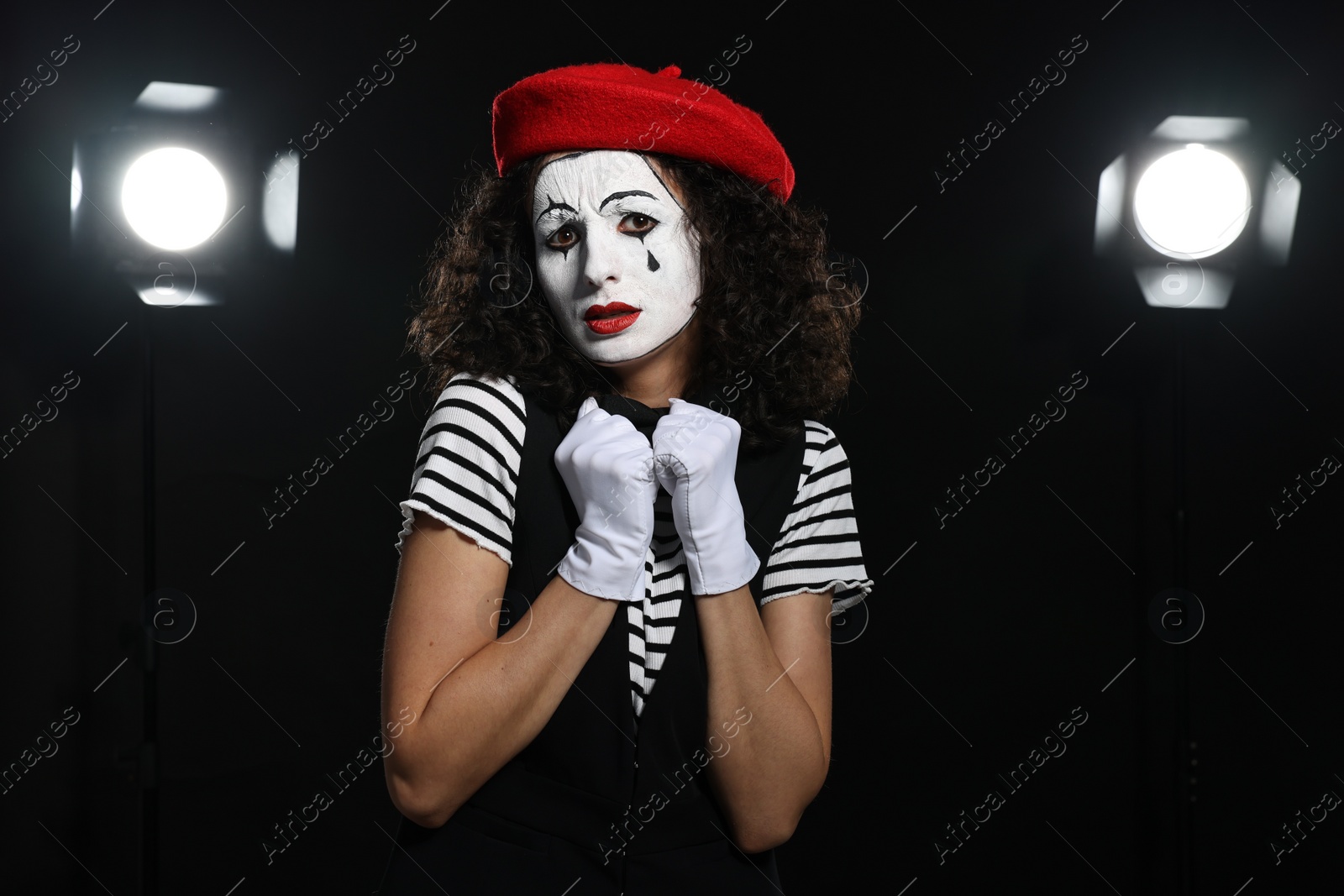 Photo of Young woman in mime costume performing on stage
