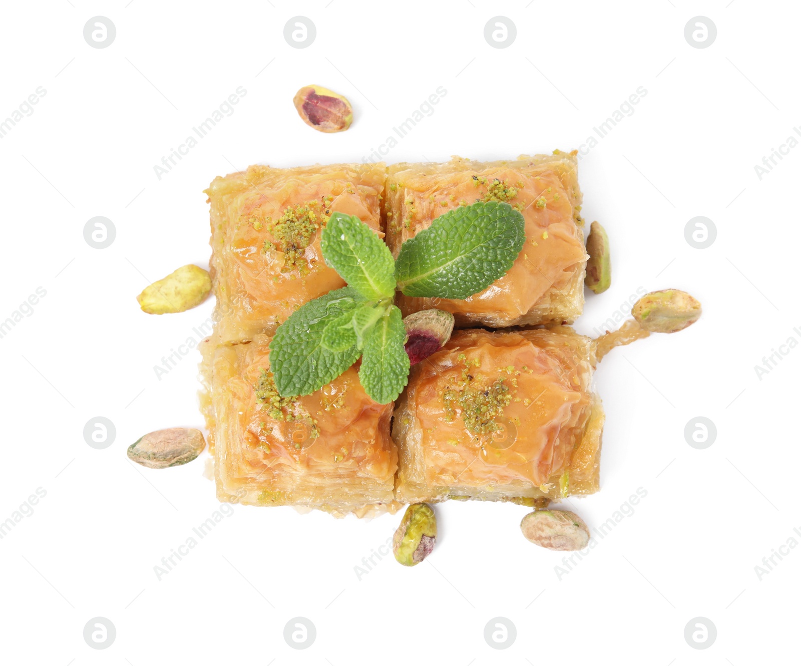 Photo of Delicious baklava with pistachios, mint and scattered nuts on white background, top view