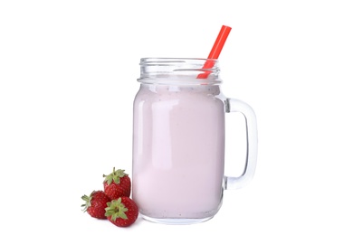 Photo of Tasty fresh milk shake in mason jar with strawberries on white background