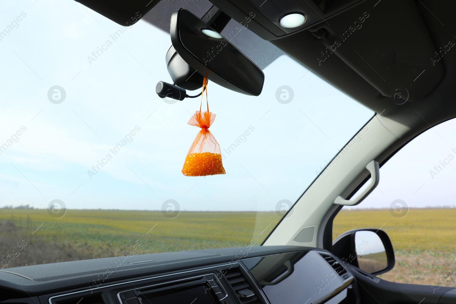 Photo of Air freshener hanging on rear view mirror in car