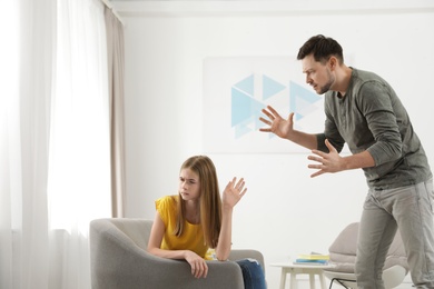 Father scolding his teenager daughter at home