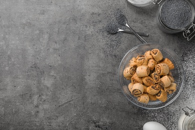 Photo of Tasty sweet cookies with poppy seeds on gray table, flat lay. Space for text