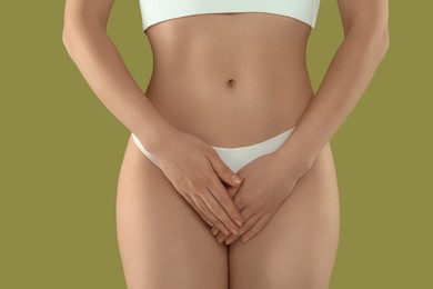 Photo of Gynecology. Woman in underwear on green background, closeup