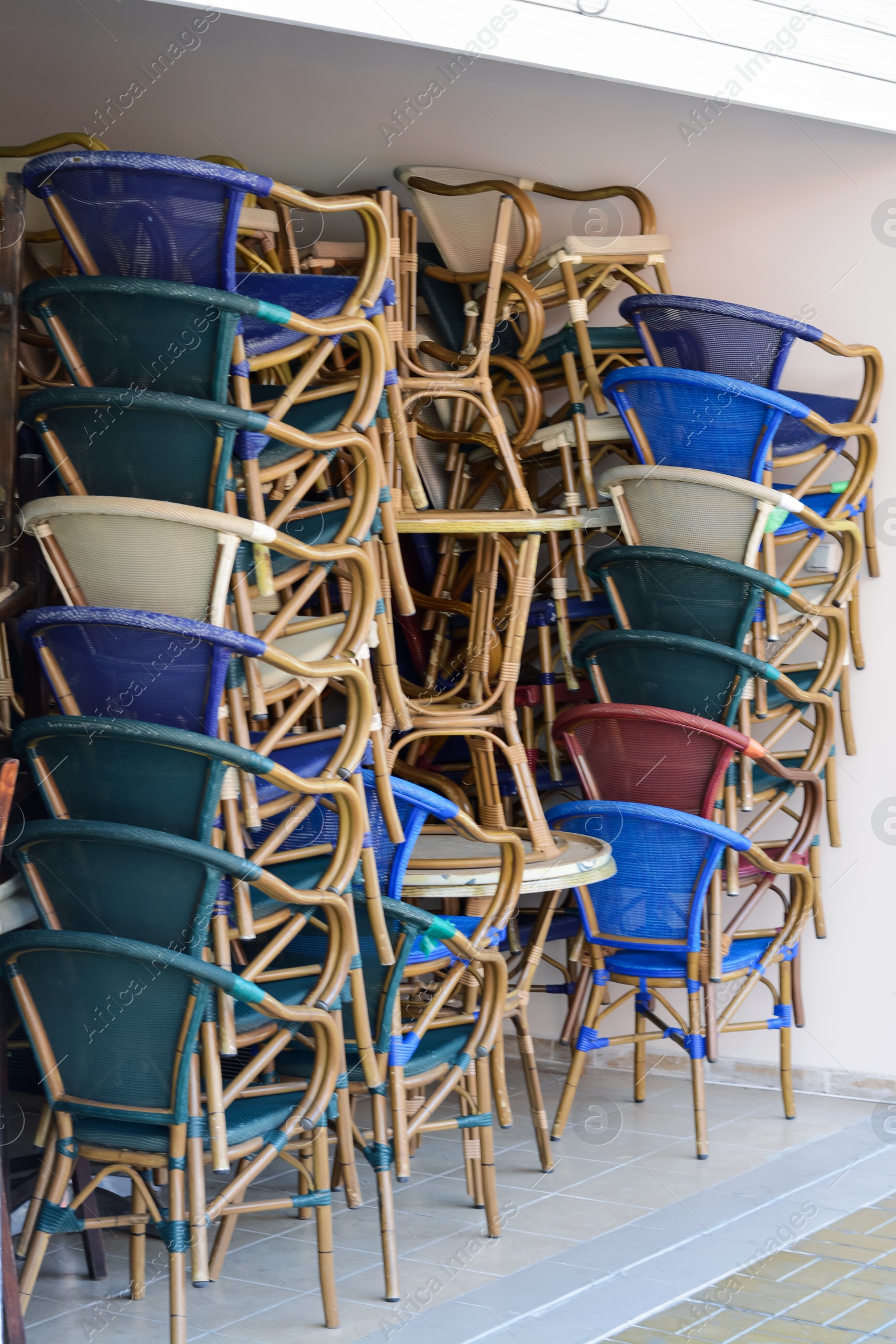 Photo of Stack of chairs and tables outdoors on sunny day