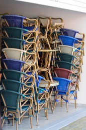 Stack of chairs and tables outdoors on sunny day