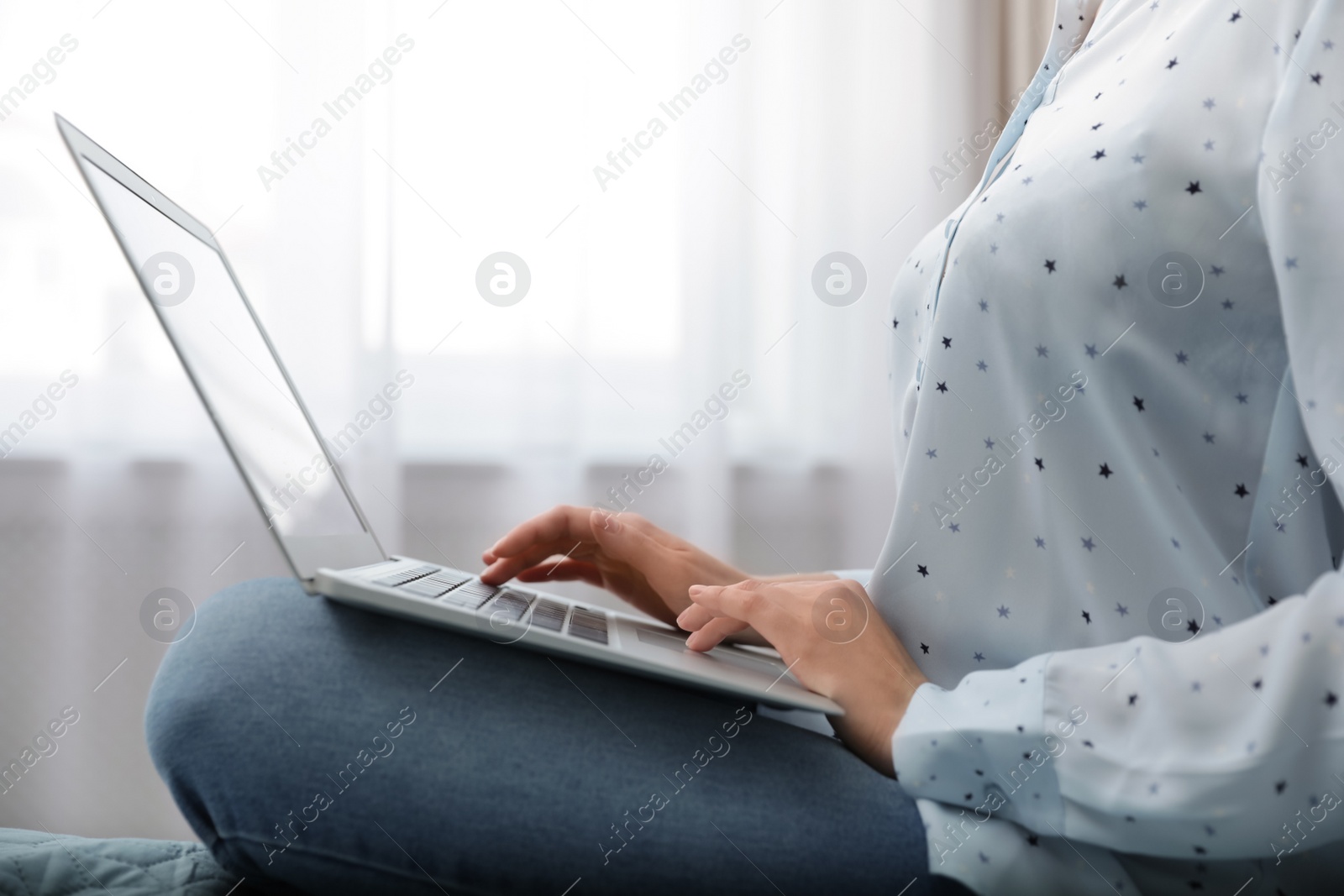 Photo of Blogger working with modern laptop at home, closeup