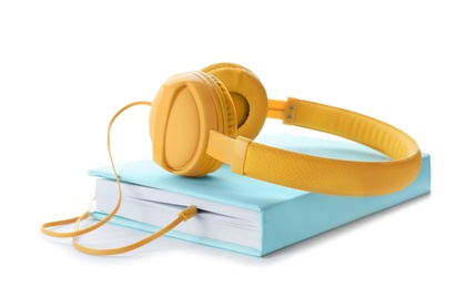Photo of Modern headphones with hardcover book on white background
