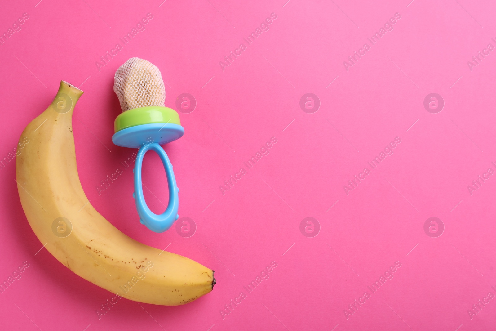 Photo of Nibbler with fresh banana on pink background, flat lay. Space for text