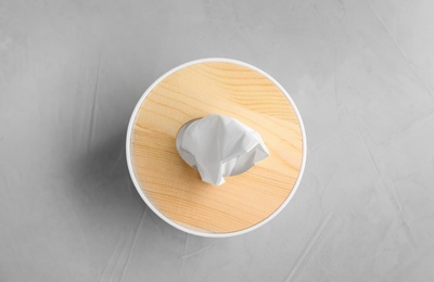 Wooden box of tissues on light table, top view