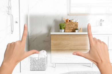 Image of Woman showing frame gesture and making bathroom real out of drawing