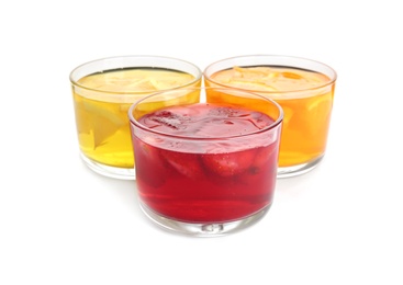 Tasty jelly desserts in glasses on white background