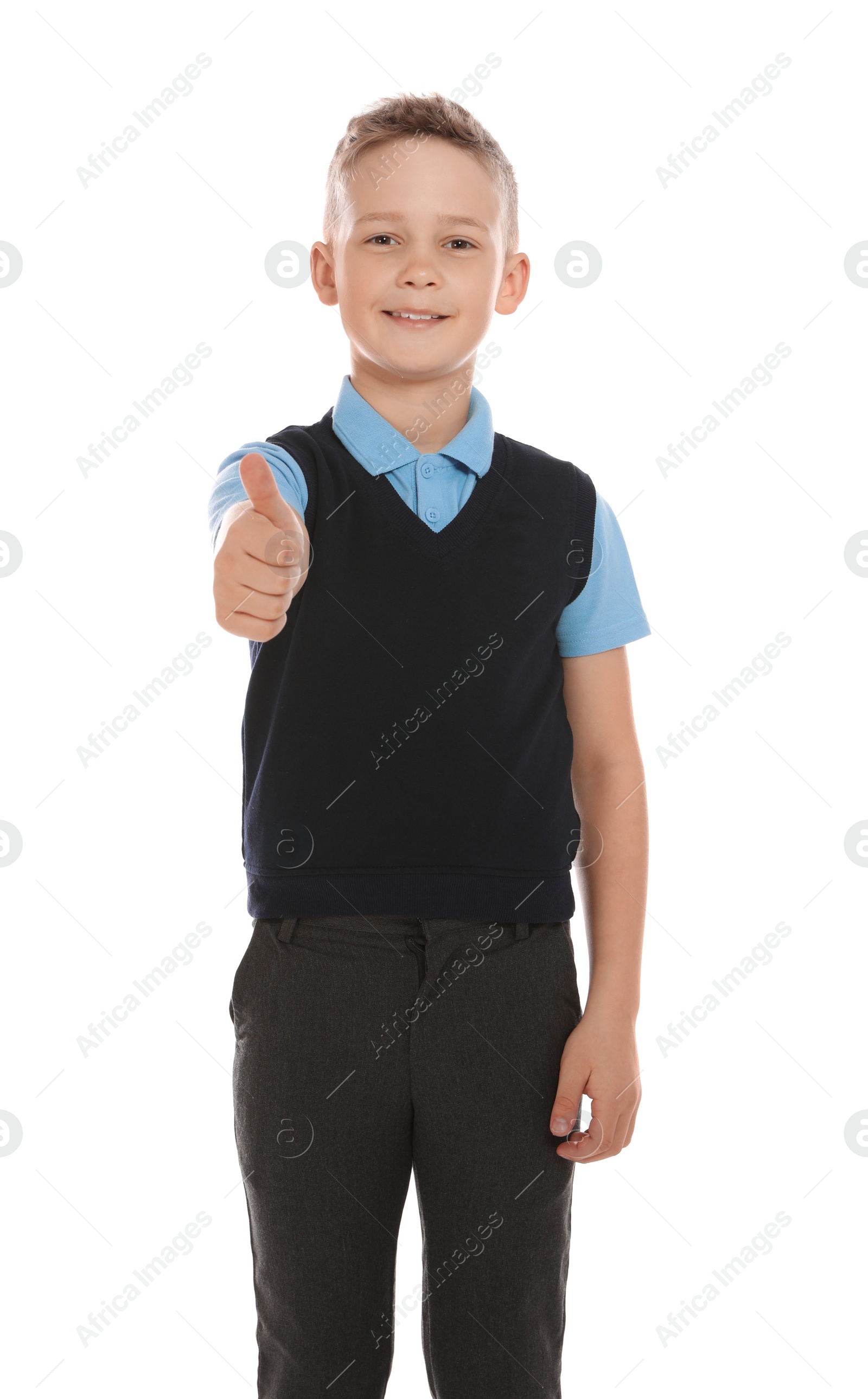 Photo of Portrait of cute boy in school uniform on white background