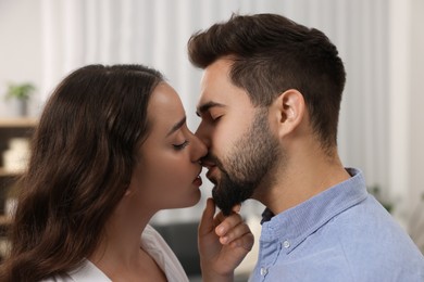 Photo of Love relationship. Passionate young couple kissing at home