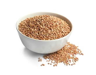 Bowl with uncooked buckwheat on white background