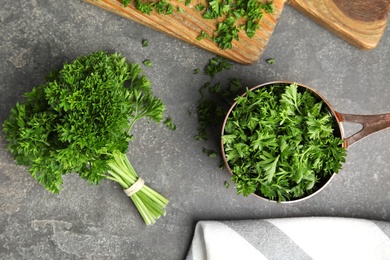 Photo of Flat lay composition with fresh green parsley on grey table