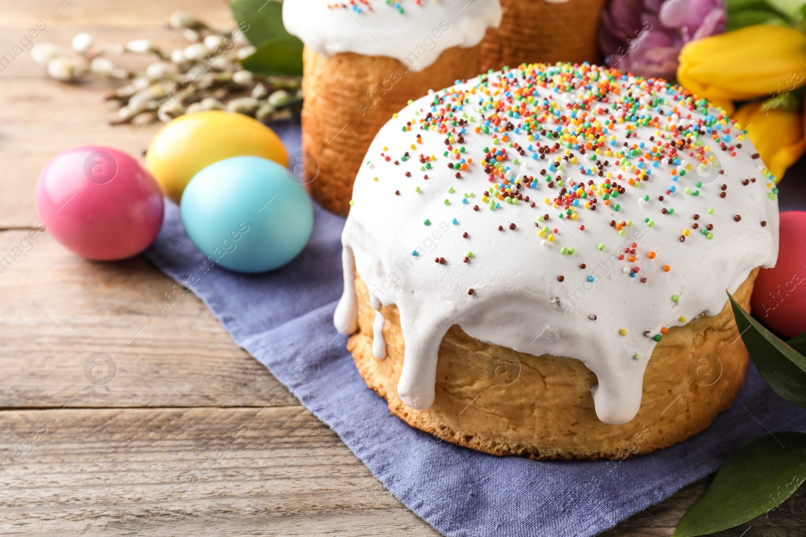 Photo of Beautiful Easter cake and painted eggs on wooden table