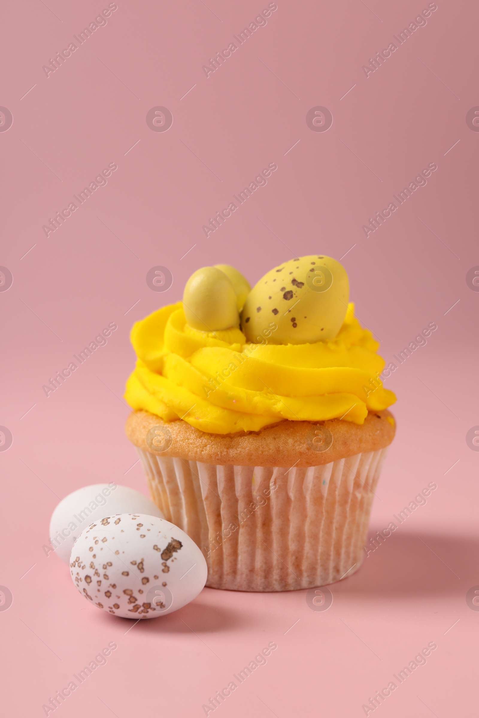 Photo of Tasty cupcake with Easter decor on pink background, closeup