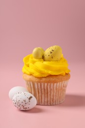 Photo of Tasty cupcake with Easter decor on pink background, closeup