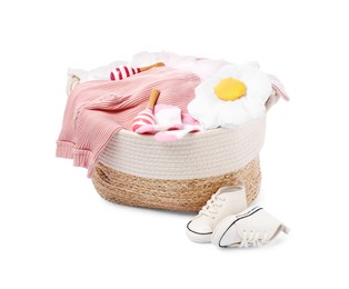 Photo of Laundry basket with baby clothes and shoes isolated on white