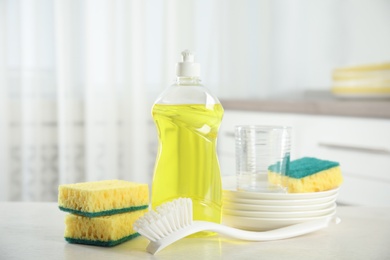 Photo of Cleaning supplies for dish washing on table indoors