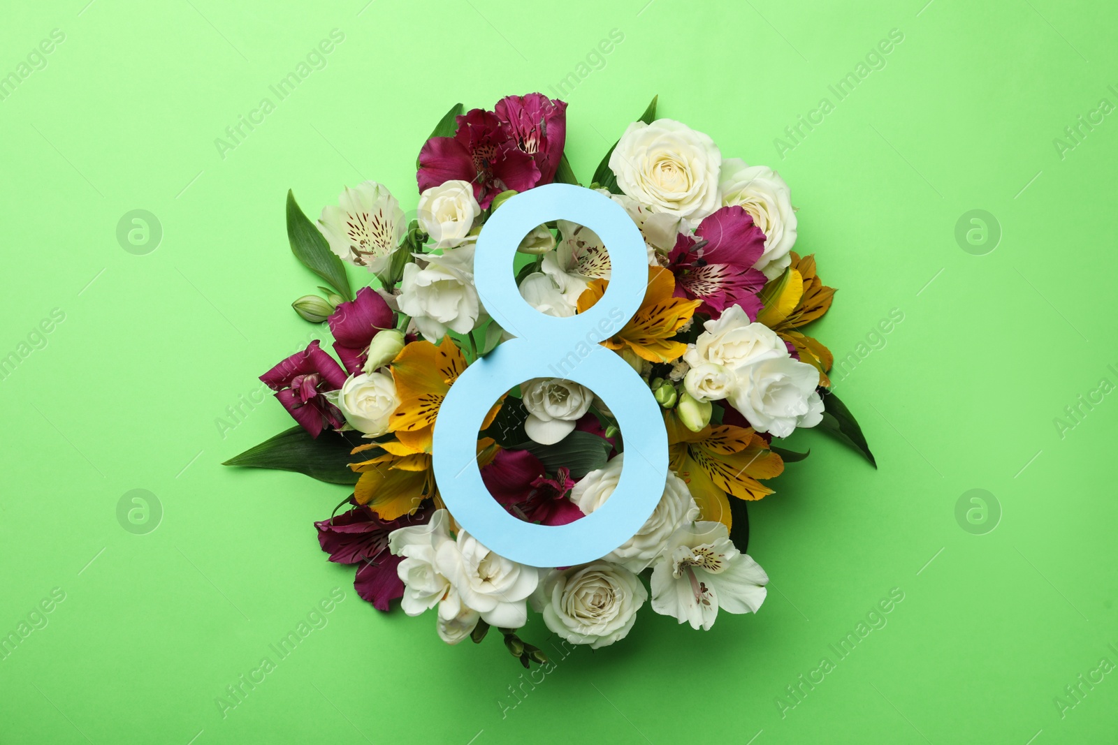 Photo of 8 March greeting card design with beautiful flowers on green background, flat lay. International Women's day